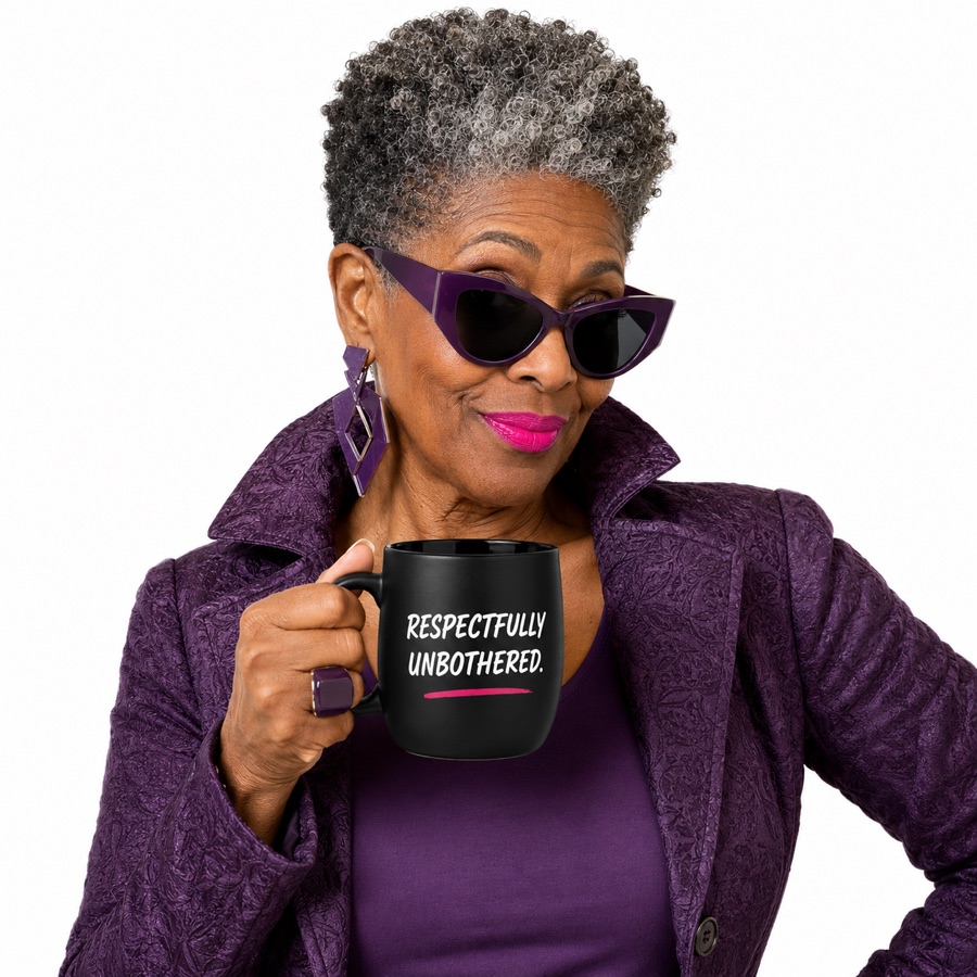 Model in plum holding the Respectfully Unbothered mug.